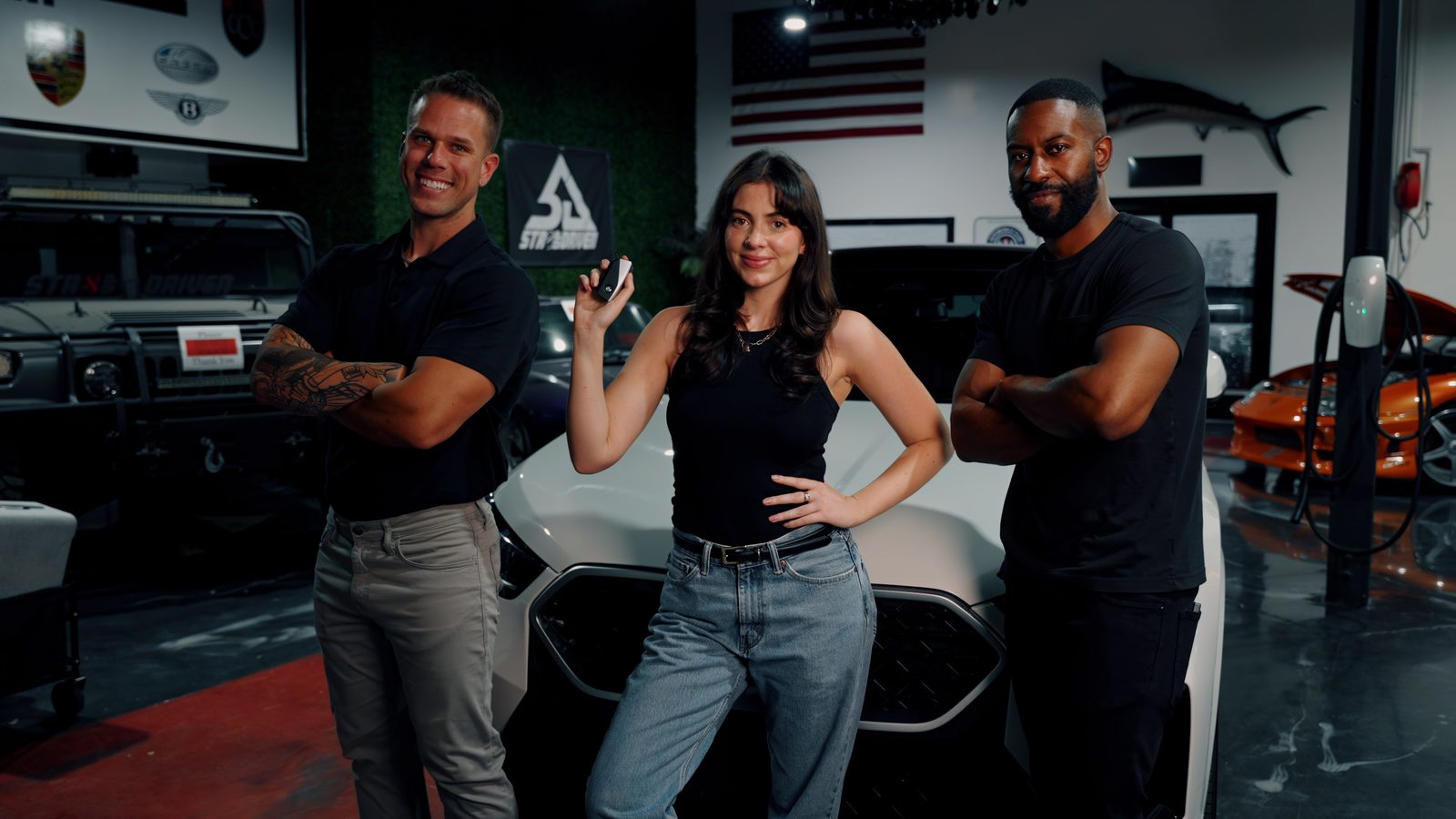 The Vorlex Motors team in the San Jose shop, standing in front of a vehicle.